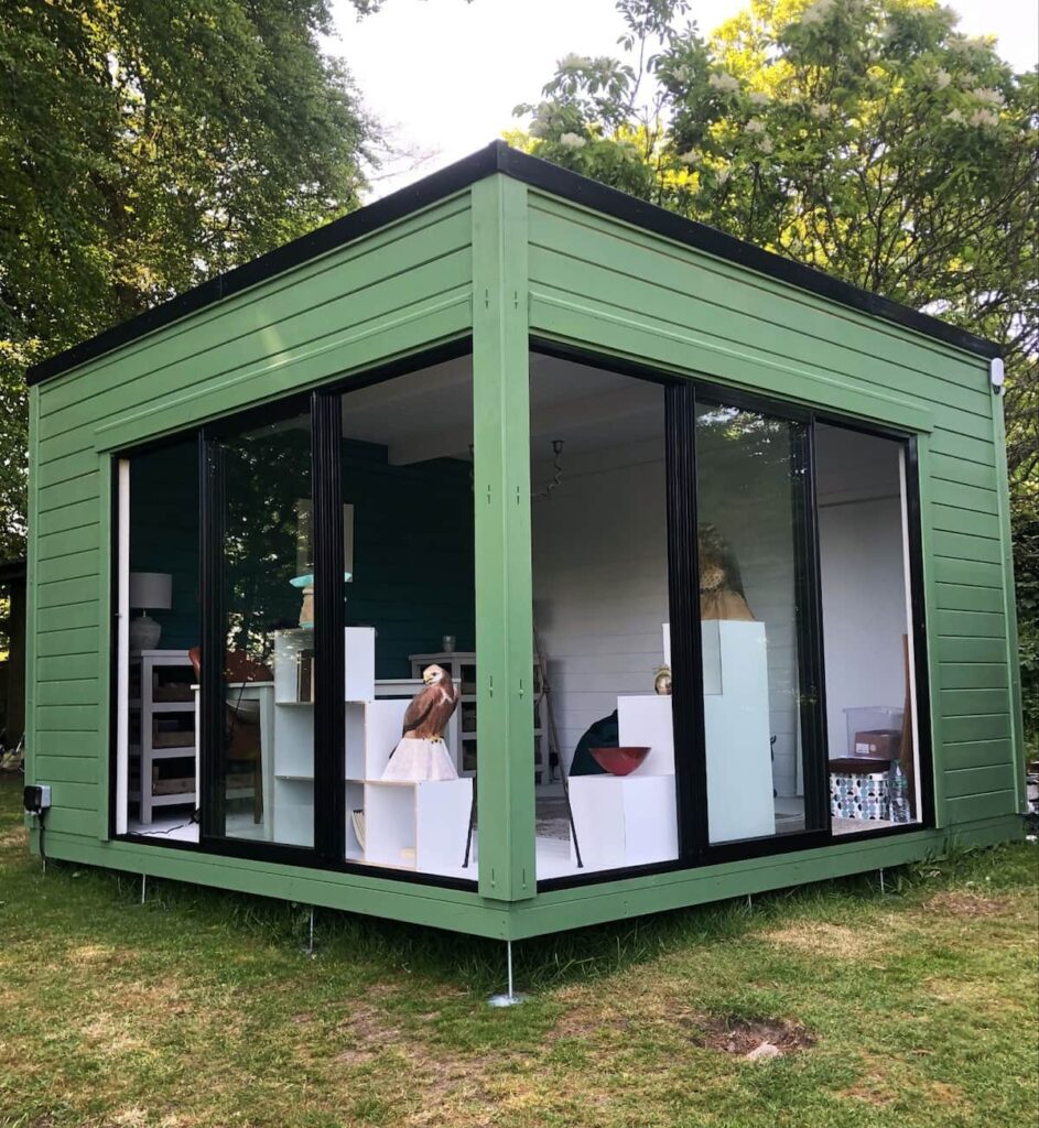 green summerhouse with large windows