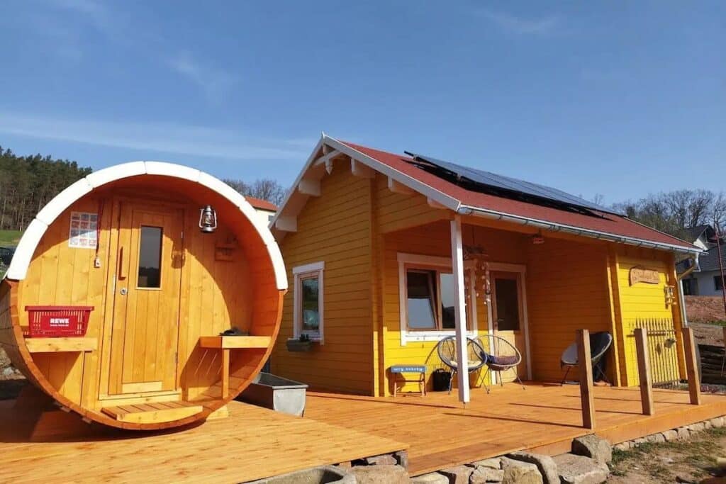 summerhouse and barrel sauna in warm yellow colour